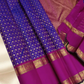 An heirloom-worthy drape woven in the finest 2G pure silk, this traditional Kanchipuram saree brings together the timeless beauty of zari buttas and checks in a rich purple body. The contrast magenta-pink rettapet border stands bold and elegant