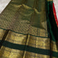Folded saree showing red body with gold buttas and wide green zari woven elephant border
