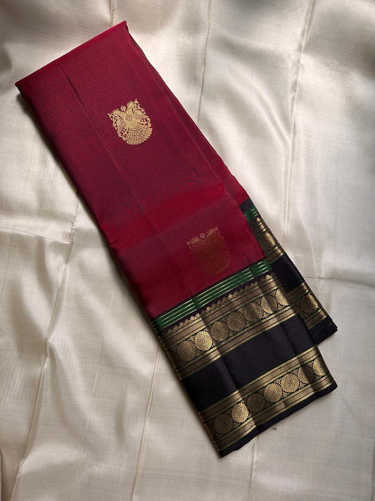 Radiant red with Gandaberunda in zari adai motif , ornate rettapet border with kamalam seer and coffee brown Pallu