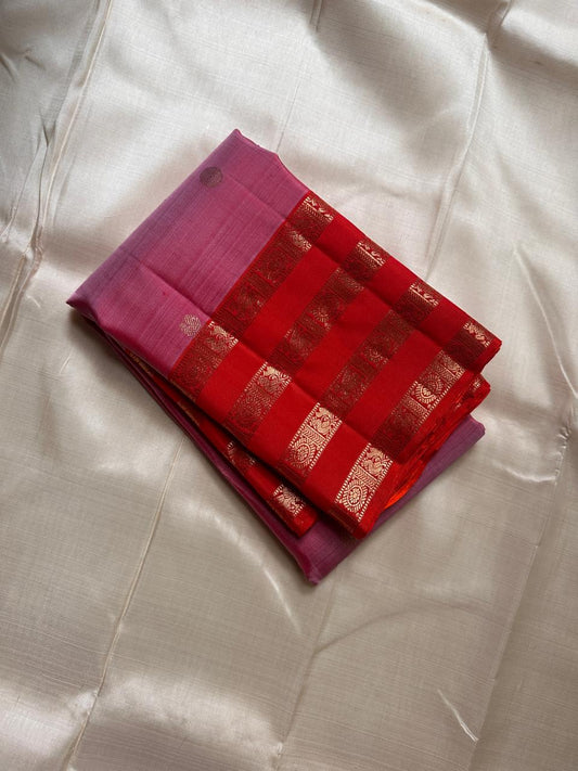 Thamarai Vermillion — Pure Kanchipuram Silk Saree
Soft orchid-pink body with zari lotus buttas and striking vermillion korvai borders, finished with a radiant orange pallu in intricate zari weave.
Silk Mark Certified • Blouse Stitching Available ($30) •