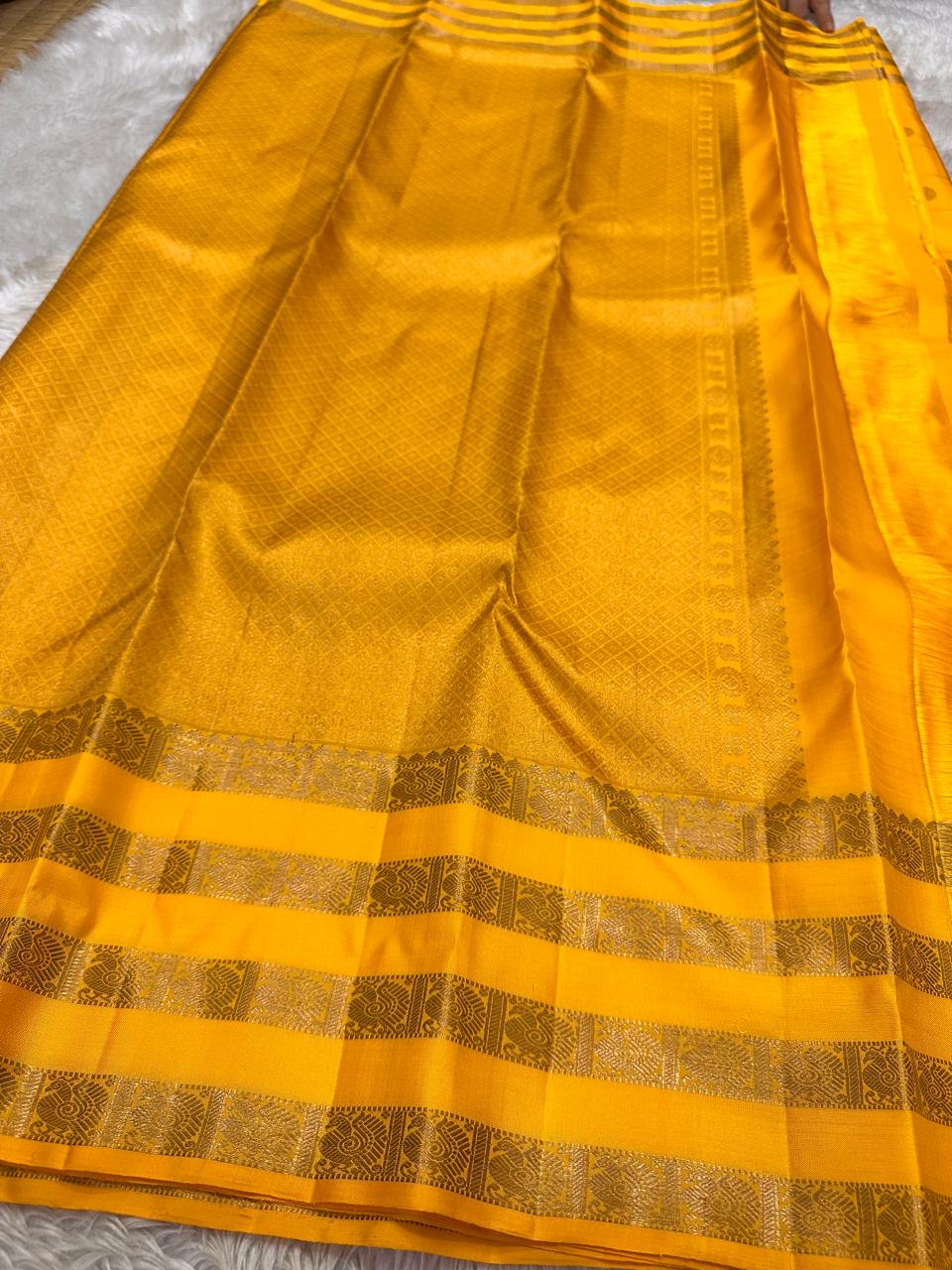 Kanaka – Sunlit Mustard Kanchipuram Silk Saree with Checked Zari Buttas and Gold Striped Border
A radiant weave that captures the warmth of tradition and the glow of celebration