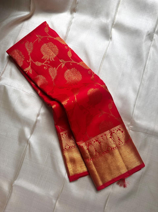 Tanvi – Vermillion Red Kanchipuram Pure Silk Saree with Floral Zari Jaal & Baavanji Border
Bold, radiant, and intricately woven varisaipettu Pallu