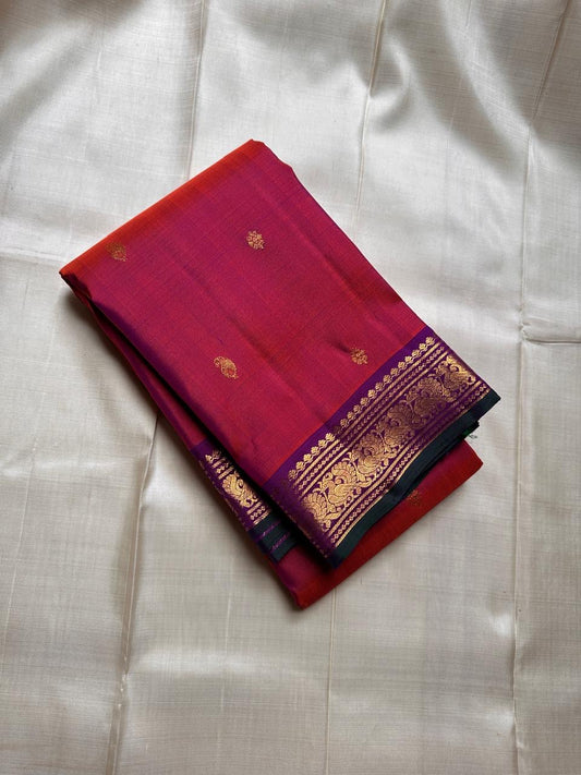 Pure silk shot rust  and red with purple mayil border with green selvedge flower ane paisley butta