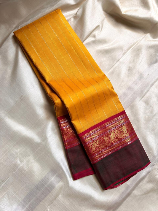 Sundaram - Bathed in the golden glow of ripe mangoes, this mambazham yellow silk saree features graceful vertical veldari stripes and delicate Sonarupa zari work. Woven with nature-inspired bird and foliage motifs