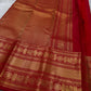 A true festival essential white with dashing red pure silk Kanchipuram saree with a kamalam and mayil detailed border zari work , red reku and Pallu