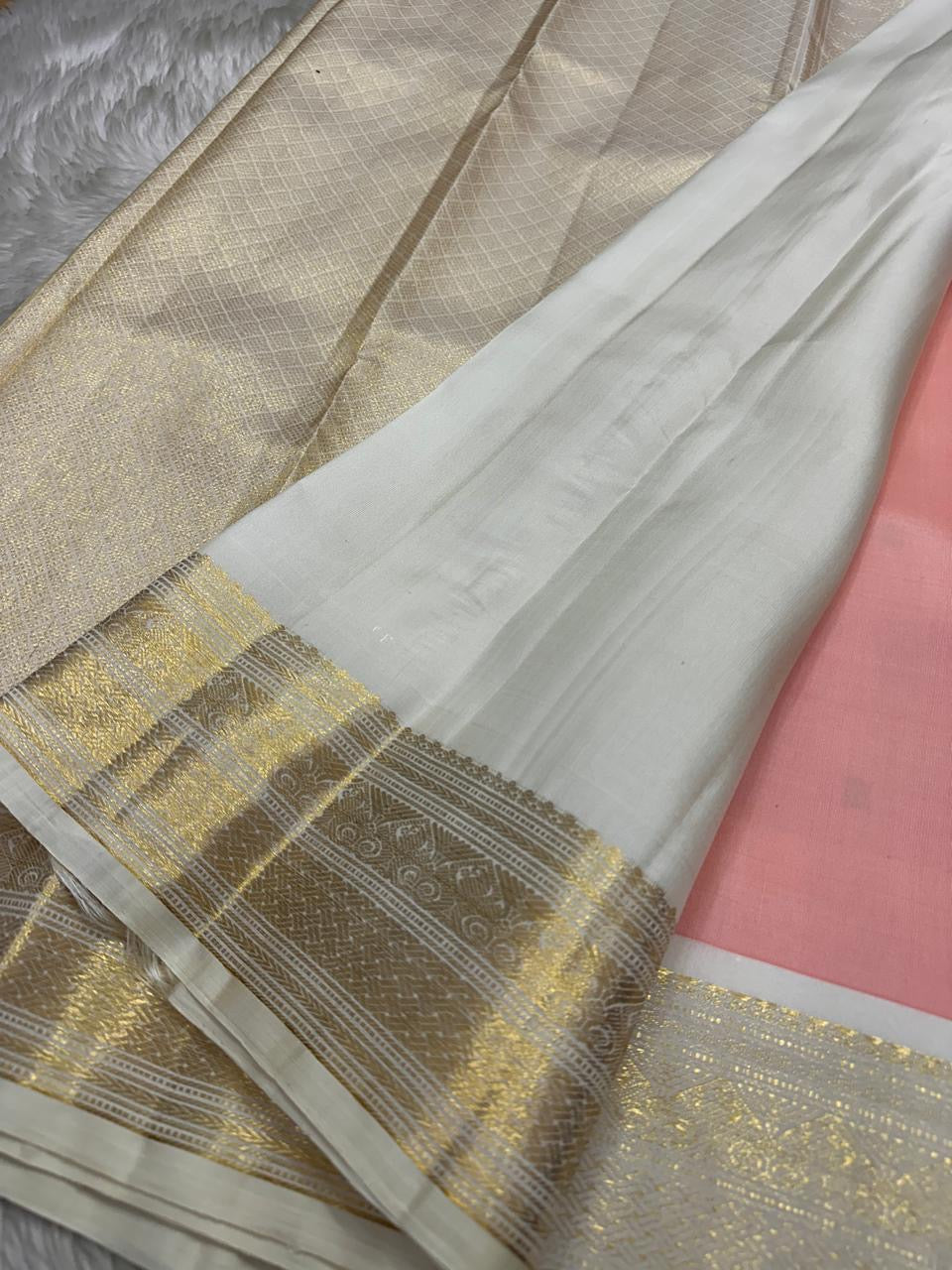 A serene blend of blush pink and pure white — soft, graceful pure silk Kanchipuram with kamalam zari butta and bavanji border and Pallu in cream