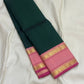 Adar pachai green pure Kanchipuram silk saree laid flat showing wide lotus pink rettapet zari border