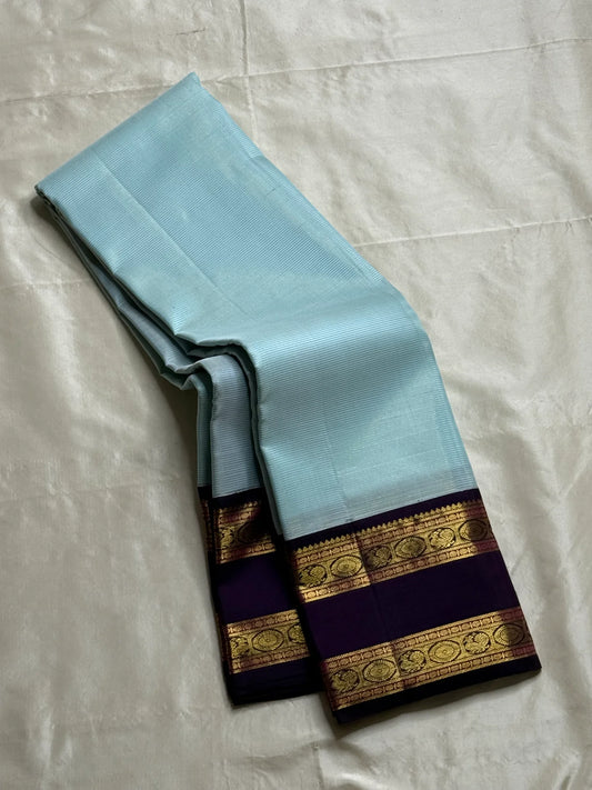 Neel Pushpa – Pure Kanchipuram Silk Saree
Pastel Powder Blue Vairaoosi Weave Body
Deep Violet Korvai Border with Zari Medallions
Antique Gold Zari Brocade Pallu, Diamond Jaal

Silk Mark Certified, delivery in 2 weeks