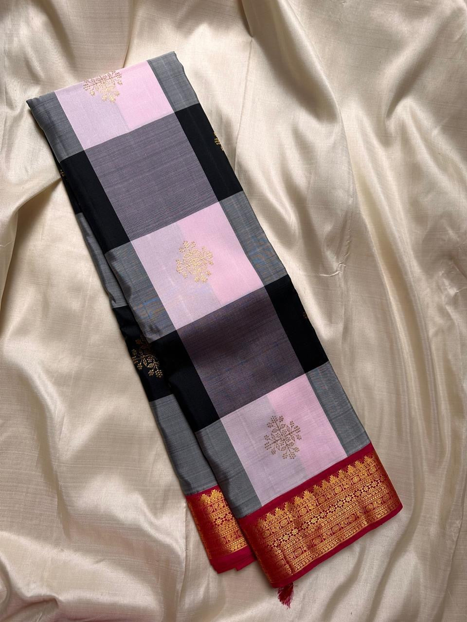Charcoal Ash Blush Kattam
Pure Kanchipuram Silk Saree – Charcoal Grey, Black & Blush Pink Checks
Contrast deep red korvai borders with intricate gold zari temple motifs
Grand zari pallu, silk mark certified.ships in 2 weeks