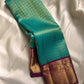 Sindhu- Teal & Purple Kanchipuram Pure Silk Saree with Floral Jaal & Mayil Border
A rich teal base adorned with delicate floral jaal and regal purple mayil borders creates timeless elegance. The diamond-motif pallu adds a bold, sophisticated finish to th