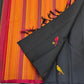 Close-up of black Pure Kanchipuram Silk Saree with yellow and red bird motifs beside an orange striped pallu with black tassels.