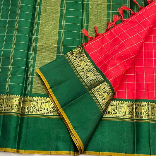 Emerald Ruby Korvai
Pure Kanchipuram Silk Saree – Ruby Red Body with muthu kattam  Grid Checks
Emerald Green Korvai Borders Adorned with Zari Elephant Motifs
Grand Green Zari seer Pallu with Traditional motifs 
Silk mark certified, ships in 2 weeks
