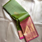 Spring green Kanchipuram silk saree with pink zari woven border and gold buttas, draped view