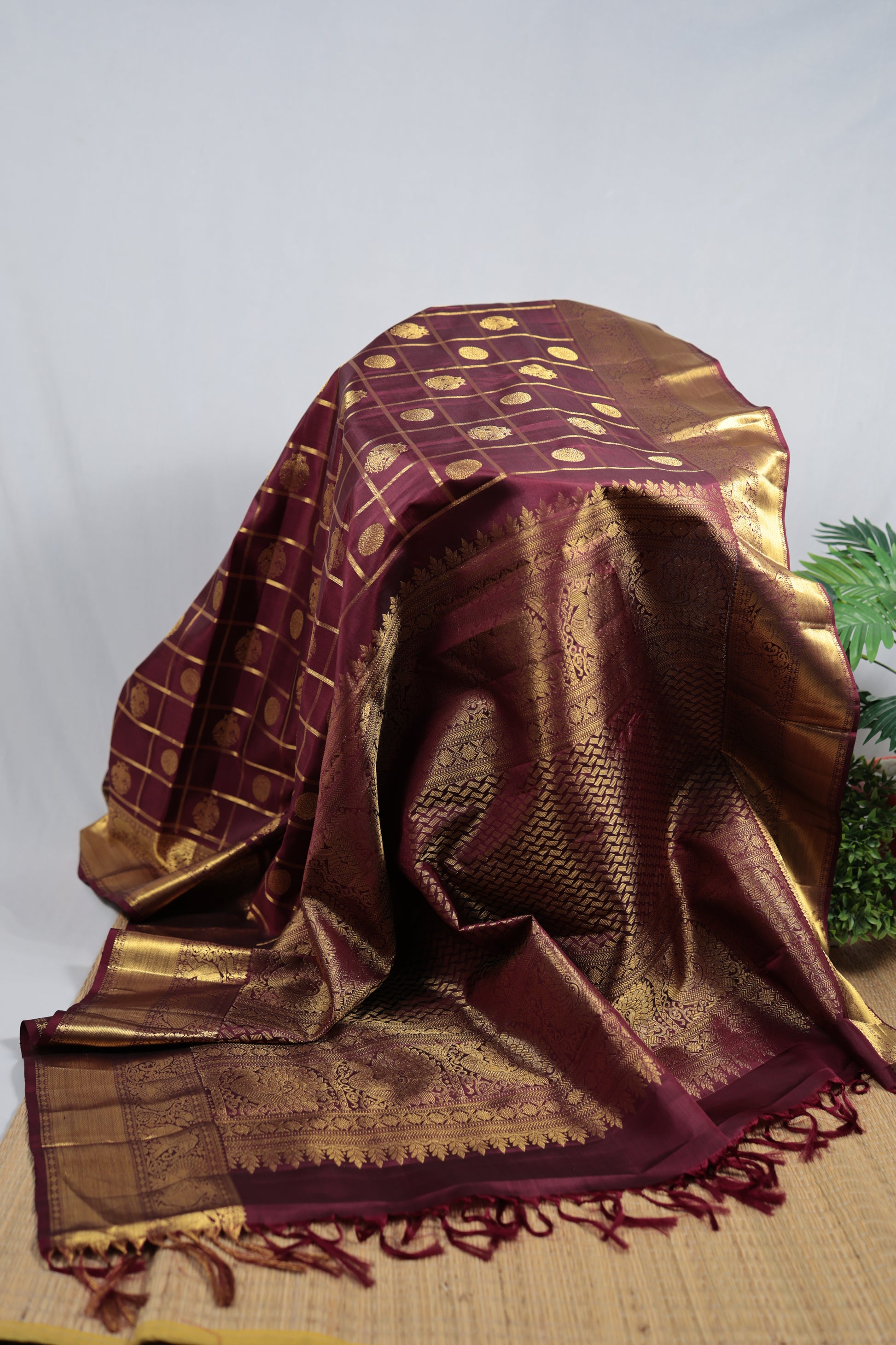 Kancheepuram silk saree wine plum body showing antique gold zari kattam check pattern