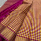 A classic Kanchipuram in Pattani Kattam checks with pink, magenta, mustard, and cream.
Finished with a contrast pink border and pallu.
Paisley and chakram motifs in a graceful grid add timeless charm.
