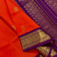 An exquisite blend of tradition and vibrancy, this silk cotton saree features a radiant orange body adorned with elegant gold zari buttas, The rich contrast border and pallu in royal purple and intricately woven with traditional gold zari motif