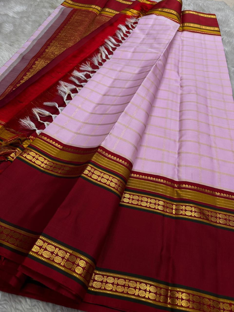 Pastel Pink Zari Kattam
Blush-pink  Kanchipuram Silk Saree
Contrast Maroon Borders in Gold Zari