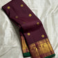 Plum & Magenta Round Butta – Pure Kanchipuram Silk Saree
Deep plum body with bold round gold zari buttas
Contrast green selvedge & gold tissue borders with magenta detailing
Grand magenta-pink pallu with full zari diamond jaal & geometric panels
Silk Mark
