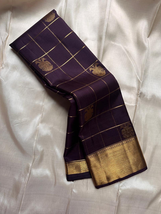 Midnight Plum Kattam Royale
Pure Kanchipuram Silk · Gold Zari Woven Grid
Temple Buttas + Majestic Zari Border Ensemble