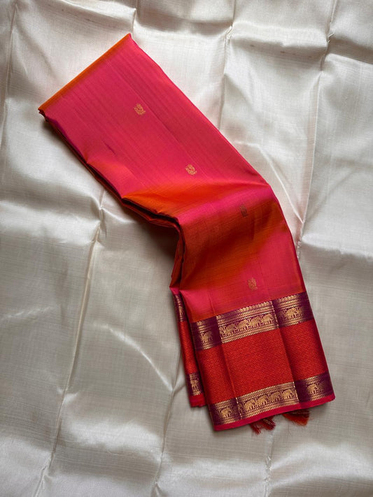 Suryarekha – Pure Korvai Kanchipuram Silk Saree
Kesari-Orange & Pink dual-tone body with gold paisley buttas
Arakku Red korvai border with diamond brocade elephant  motifs
Vadamalli Purple grand zari brocade pallu | shios in 2 weeks ,silk mark cer