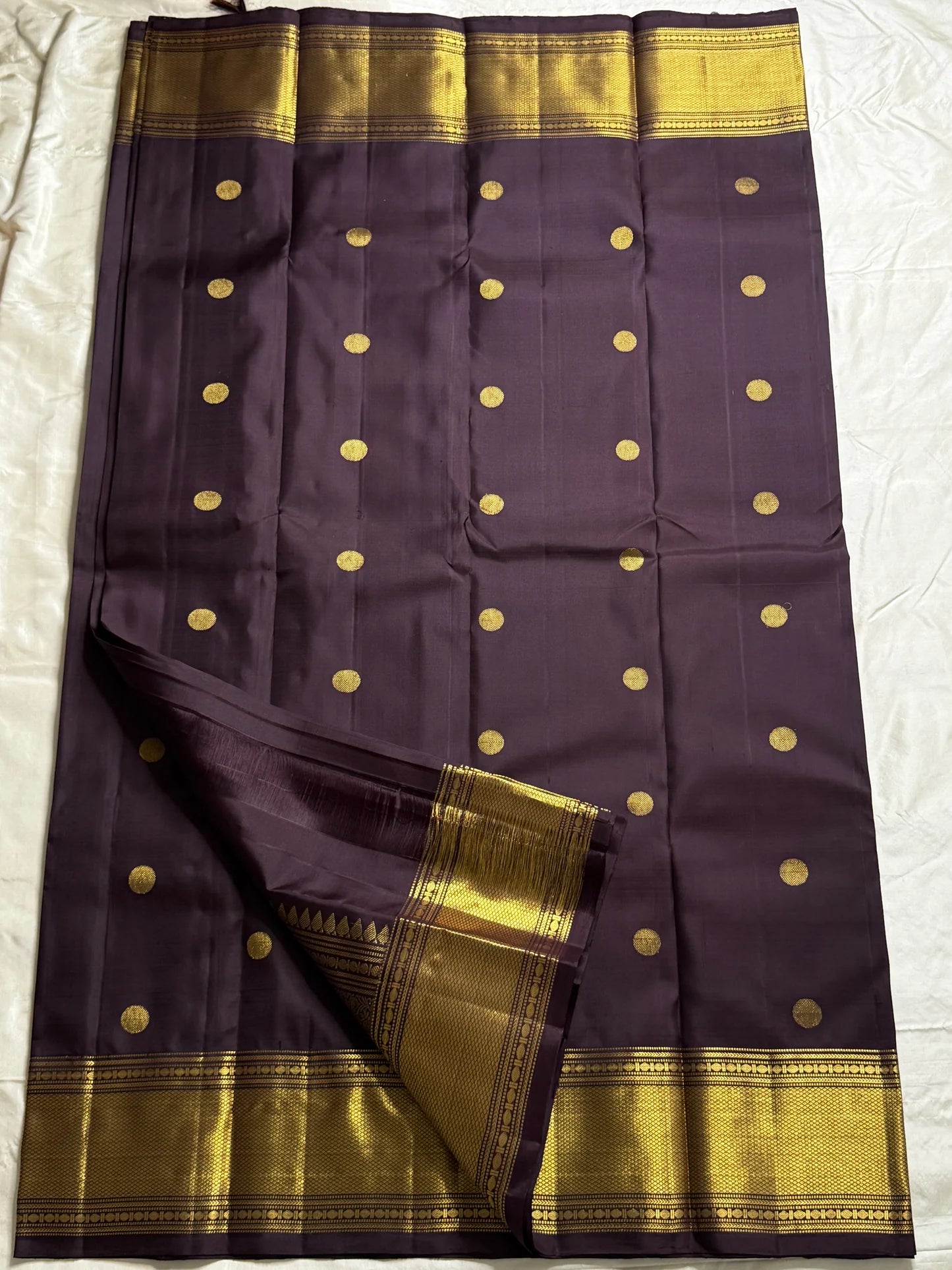 Nagavalli – A Midnight Jamun Dream in Kanchipuram Silk, Woven with Gold Coin Buttas, Temple-Inspired Arai Maadam Border, and Rudhraksham Seer in Lustrous Zari