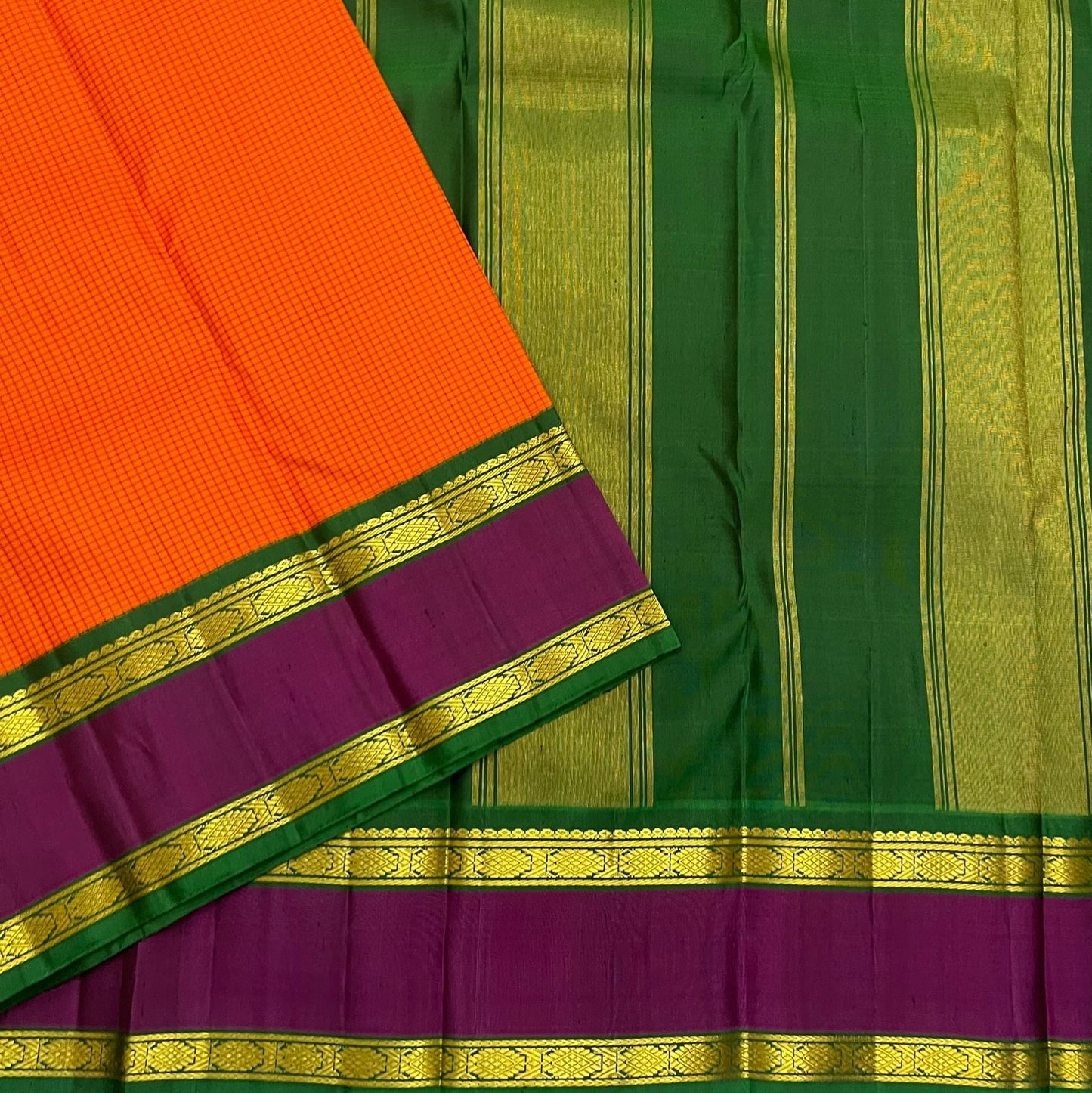 Sunset Kattam — Pure Kanchipuram Silk Saree
Sunset-orange kattam body with royal purple borders and emerald green pallu in fine zari.
Silk Mark Certified • Free Shipping within USA • Ships in Two Weeks