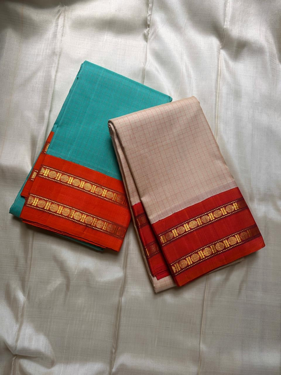 Sharvani Red– Cream Checked Silk Saree with Red Orange shot color Zari Border & Vibrant Pallu
A timeless silk saree featuring a cream body with delicate red checks, complemented by a striking red zari border pallu.