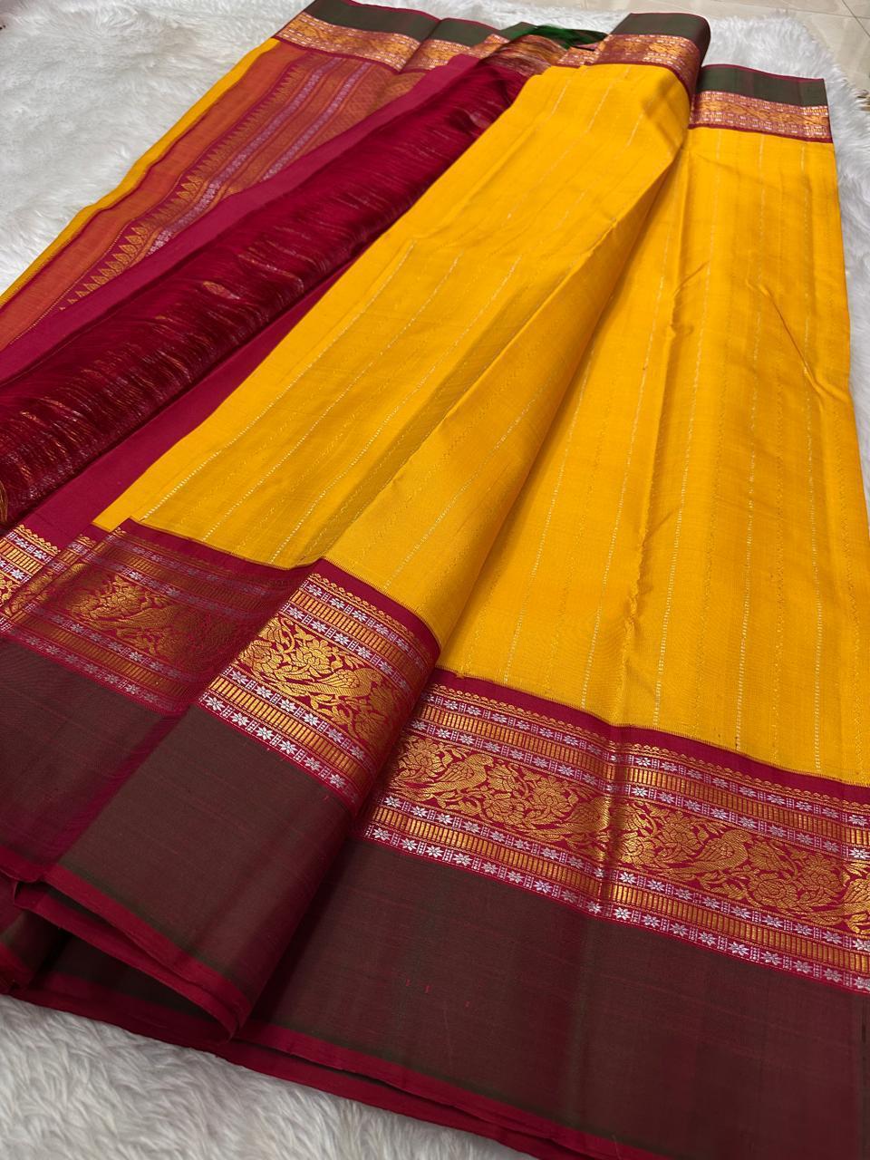 Sundaram - Bathed in the golden glow of ripe mangoes, this mambazham yellow silk saree features graceful vertical veldari stripes and delicate Sonarupa zari work. Woven with nature-inspired bird and foliage motifs