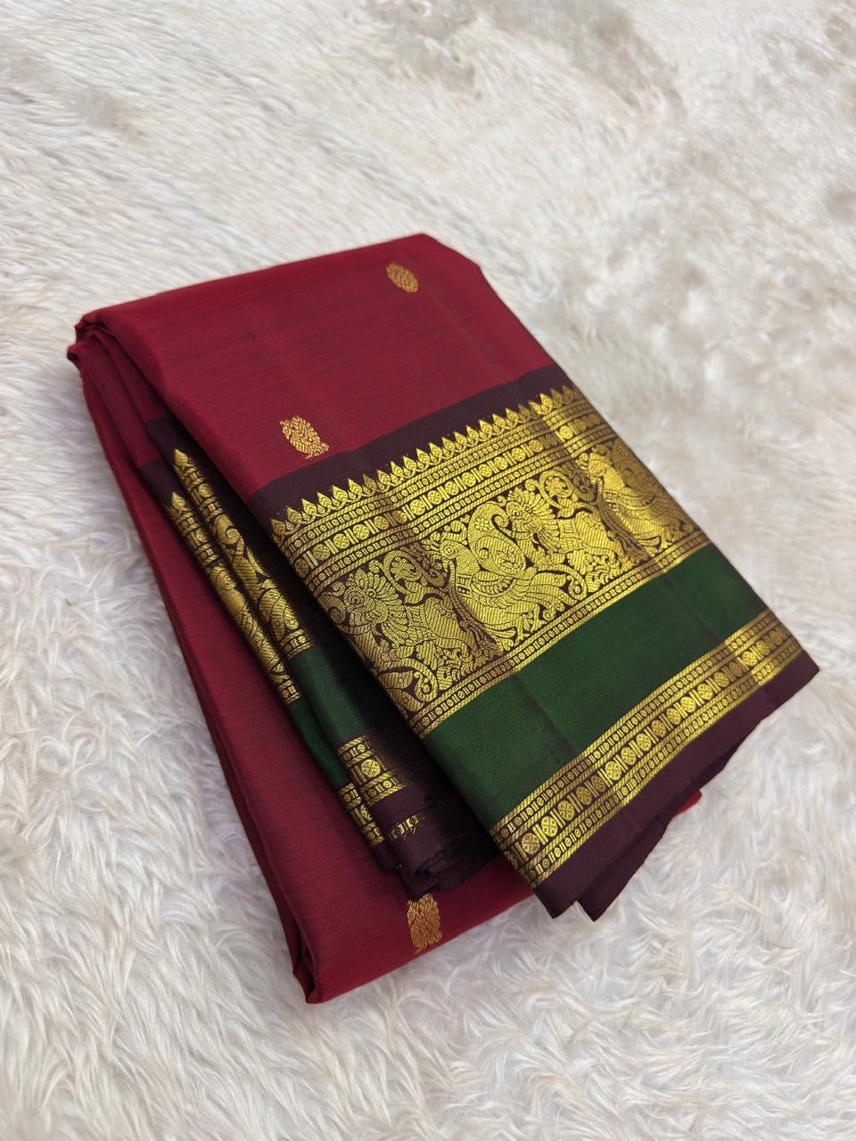 Mayil butta in gold zari close-up on arakku red Kanjipuram pure silk saree — Idam Living