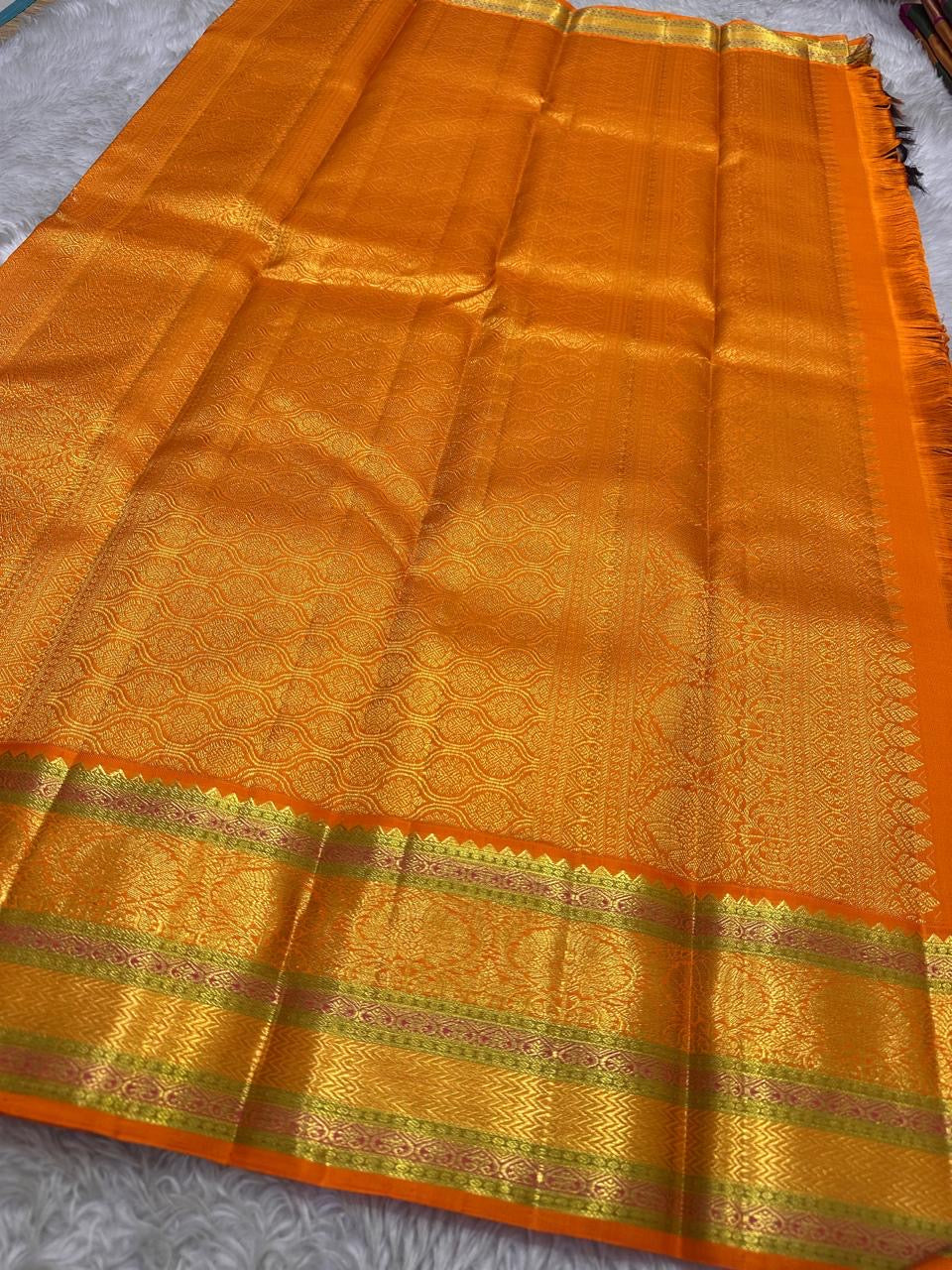 Jamun Purple Kesar – Korvai Kanchipuram Pure Silk Saree

Regal jamun-purple body adorned with antique-gold floral buttas

Kesari-orange korvai border with chakra roundels, vines & chevron zari

Free shipping withinUSA silk mark certified ships in 2 weeks