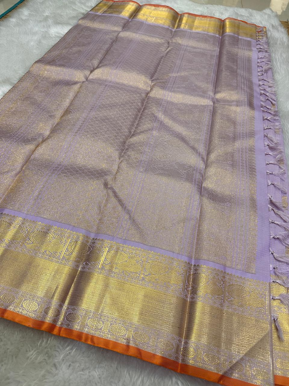 Lilavathi — Lavender & Gold Korvai
Pure Silk Kanchipuram Saree with Coin & Mango Zari Buttas
Antique-Gold Peacock Border • Grand Zari Pallu •
Silk Mark Certified ✅ Fall & Pico Done ✅ Blouse Stitching Available ($30) ✅
Free Shipping within 4 weeks