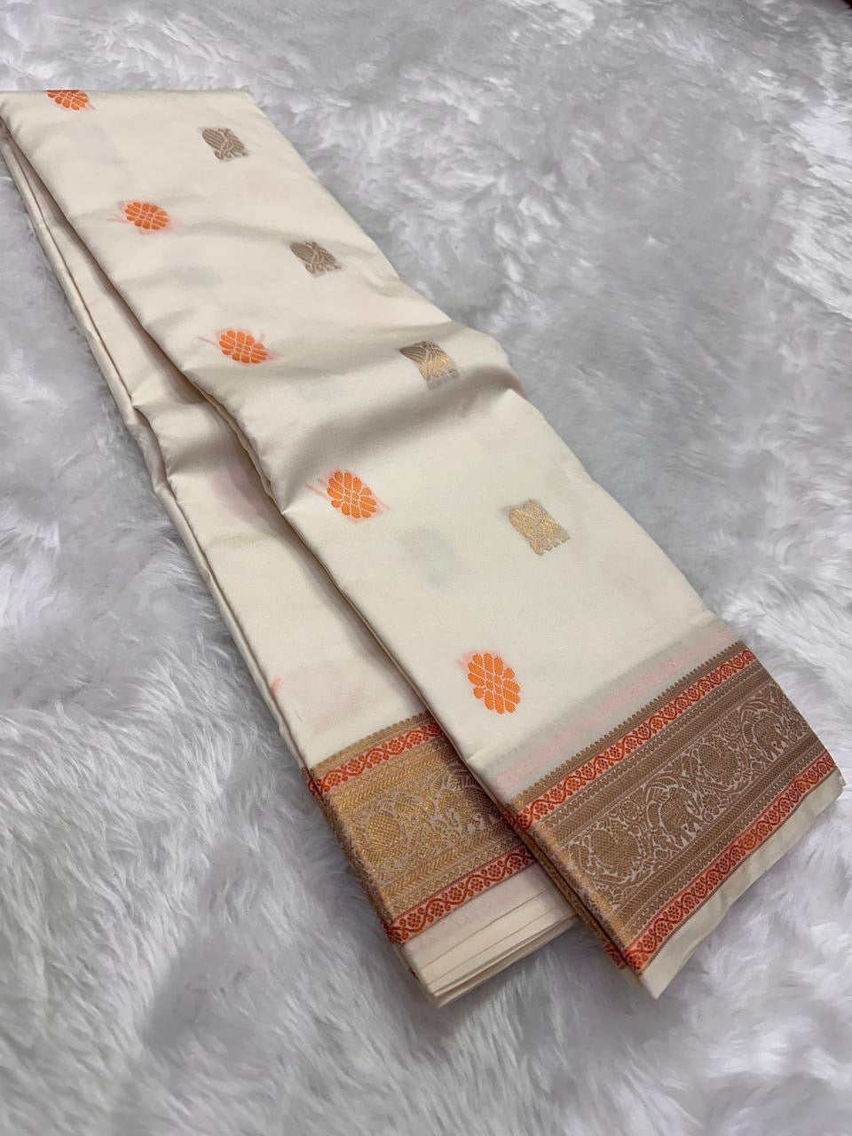 Ivory Swarna — Pure Kanchipuram Silk Saree
Ivory body with marigold rosette and antique-gold paisley buttas, framed in champagne-gold elephant brocade borders.
Silk Mark Certified • Free Shipping within USA • Dispatch in 1 Week • Ships in Two Weeks ✅