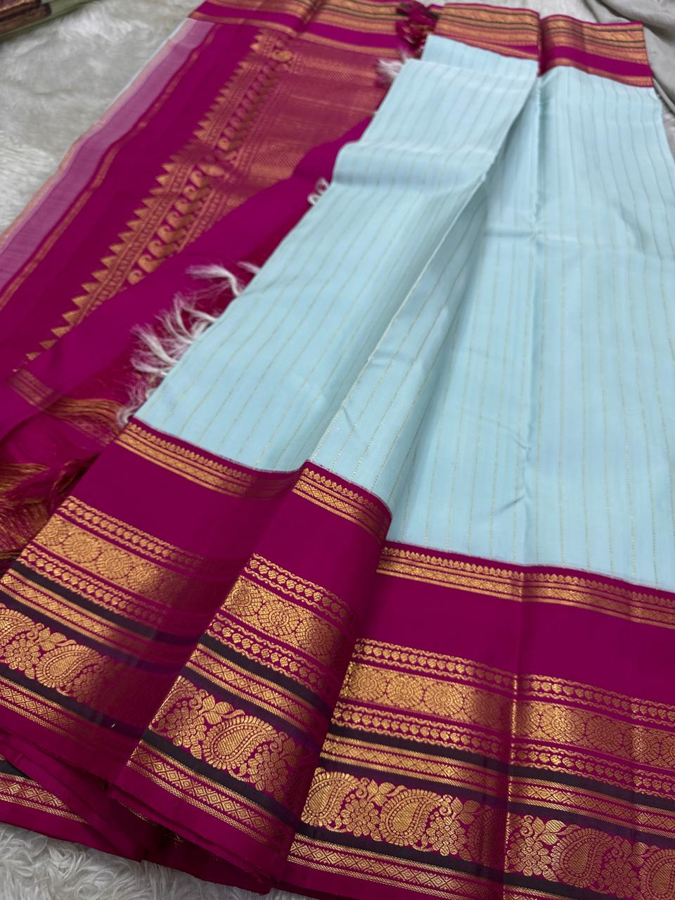 Orchid Sky ✨ – Pure Kanchipuram Silk Saree in Sky-Blue with Vertical Zari Stripes
Korvai Contrast Magenta Varisaipet Border & Grand Gold Zari Pallu
Contrast Magenta Blouse Piece with Matching Zari Border Attached
Silk Mark Certified | Fall & Pico Done |