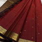 Komala – Deep Cherry Red Kanchipuram Pure Silk Saree with Coffee Brown Border
With petite kamalam motifs, peacock borders, and a grand grid zari pallu