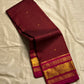 Arakku Kattam Mayura Chakram – Pure Silk Kanchipuram Saree (Maroon & Rani Pink)

Micro-check body with tiny gold buttas; vibrant rani contrast

Antique-gold peacock chakram border & grand woven zari pallu

Silk Mark Certified | Blouse Piece Included |