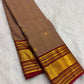 Rich ruby red border with bold circular zari medallions on a Kanchipuram saree