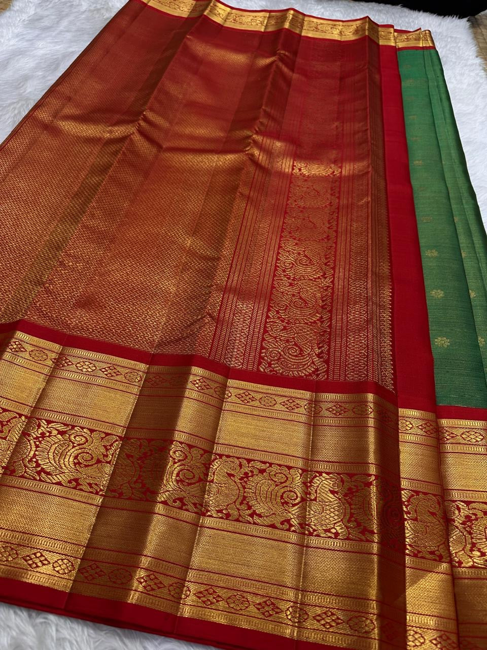 Copper-gold pallu close-up with dense micro-zari field.