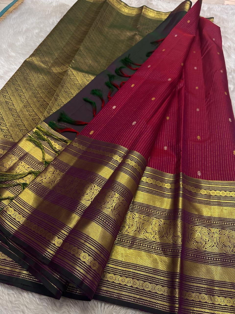 Red pure silk Kanchipuram with vertical zari stripes parrot motif varisaipet border with shot of green red Pallu