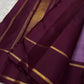 Ilam  Vadamalli Chakram — Kanchipuram Pure Silk

Pastel lilac–mauve body with gold & silver chakram buttas

Deep plum contrast border with twin kaddi zari lines

Plum pallu with elegant vertical zari stripes; lilac tassels

Silk Mark Certified •