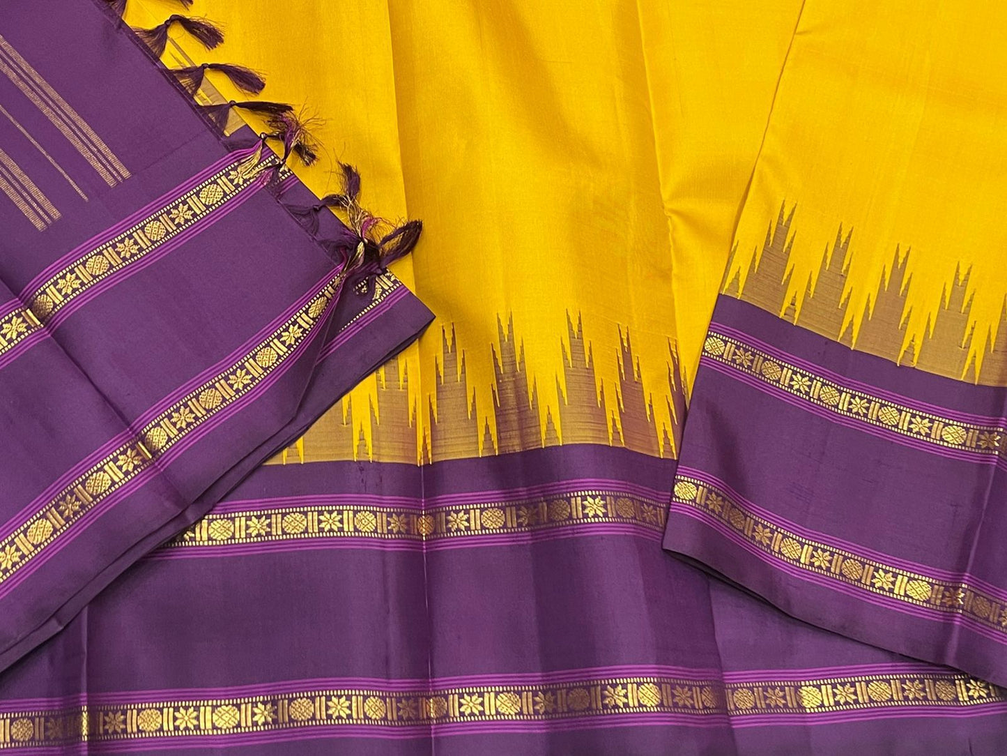 Suvarna Nitya
Mustard–Purple Kanchipuram Silk Saree
Heritage Temple Reku • Gold Zari Borders • Silk Mark Certified
