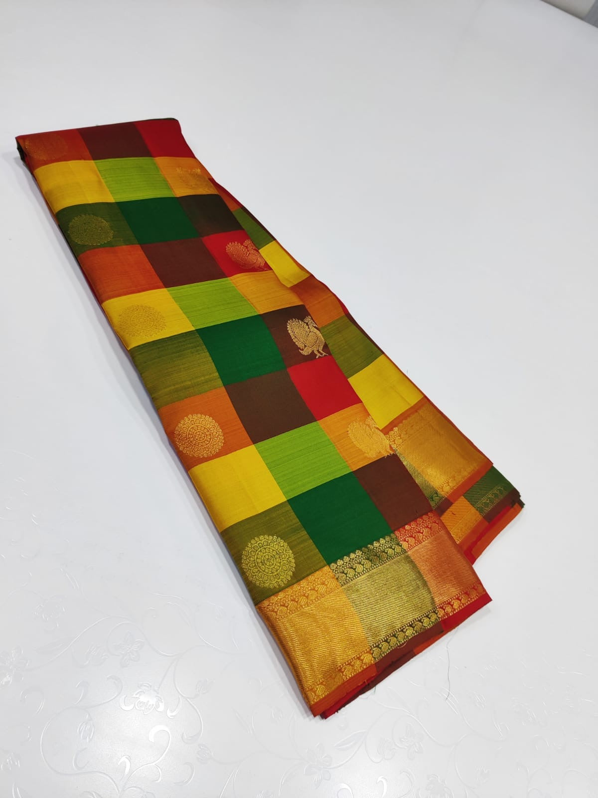 Sunset Mosaic – Paalum Pazhamum – Pure Kanchipuram Silk Saree
Vibrant Multicolored Checks in Yellow, Green, Rust & Maroon
Golden Zari Borders with Traditional Intricate Weaves

Silk Mark Certified, delivery in 2 weeks