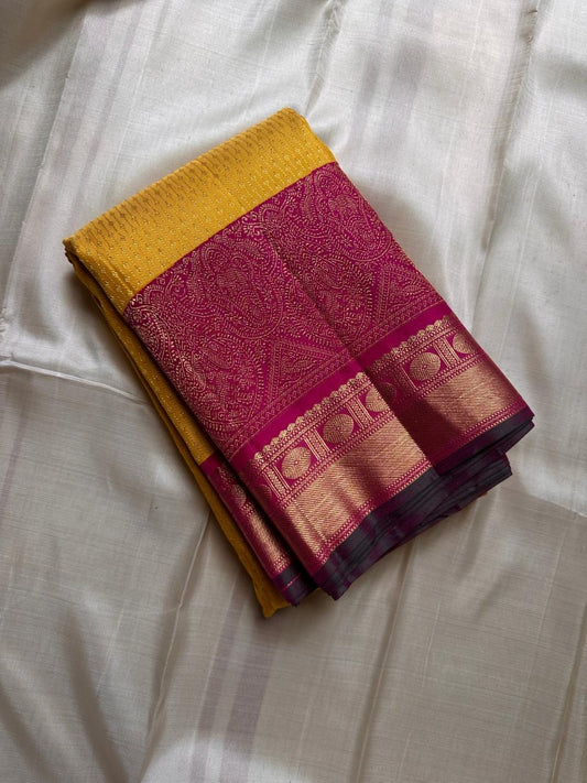 Manjula – Vibrant Yellow Pure Silk Kanchipuram Saree with Handwoven Magenta Benares-Style Dual Border, Maanthulir Green Selvedge, and Intricate Paisley, Rudhraksham & Floral Motifs on Pallu