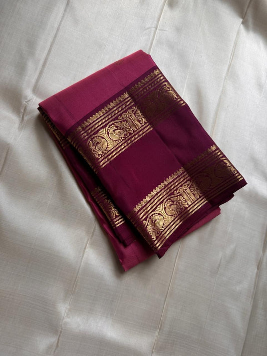 Saanvi – Lotus Pink & Magenta Shot Kanchipuram Silk Saree
Saanvi features zari buttas of mayils and chakrams across the body. A deep wine rettapettu border showcases twin peacocks in a temple arch. The pallu mirrors this grandeur with sorgavasal motifs !