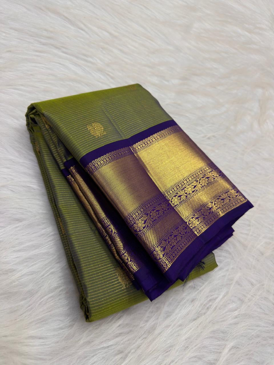 Close-up of Vairaoosi zari lines and gold Butta motifs on olive green Kancheepuram silk saree