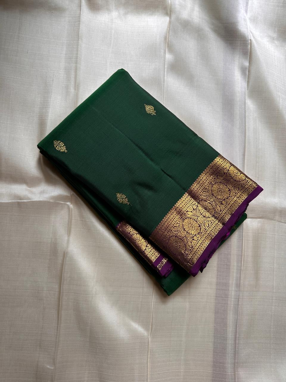 Marakatha Valli ✨ – Pure Kanchipuram Silk Saree
Emerald Green Body with Fine Zari Buttas
Royal Purple Korvai Border with Gold Zari Motifs
Majestic Purple Pallu with Rich Gold Zari Brocade
Silk Mark Certified | Fall & Pico Done | Blouse Stitching ($30) |