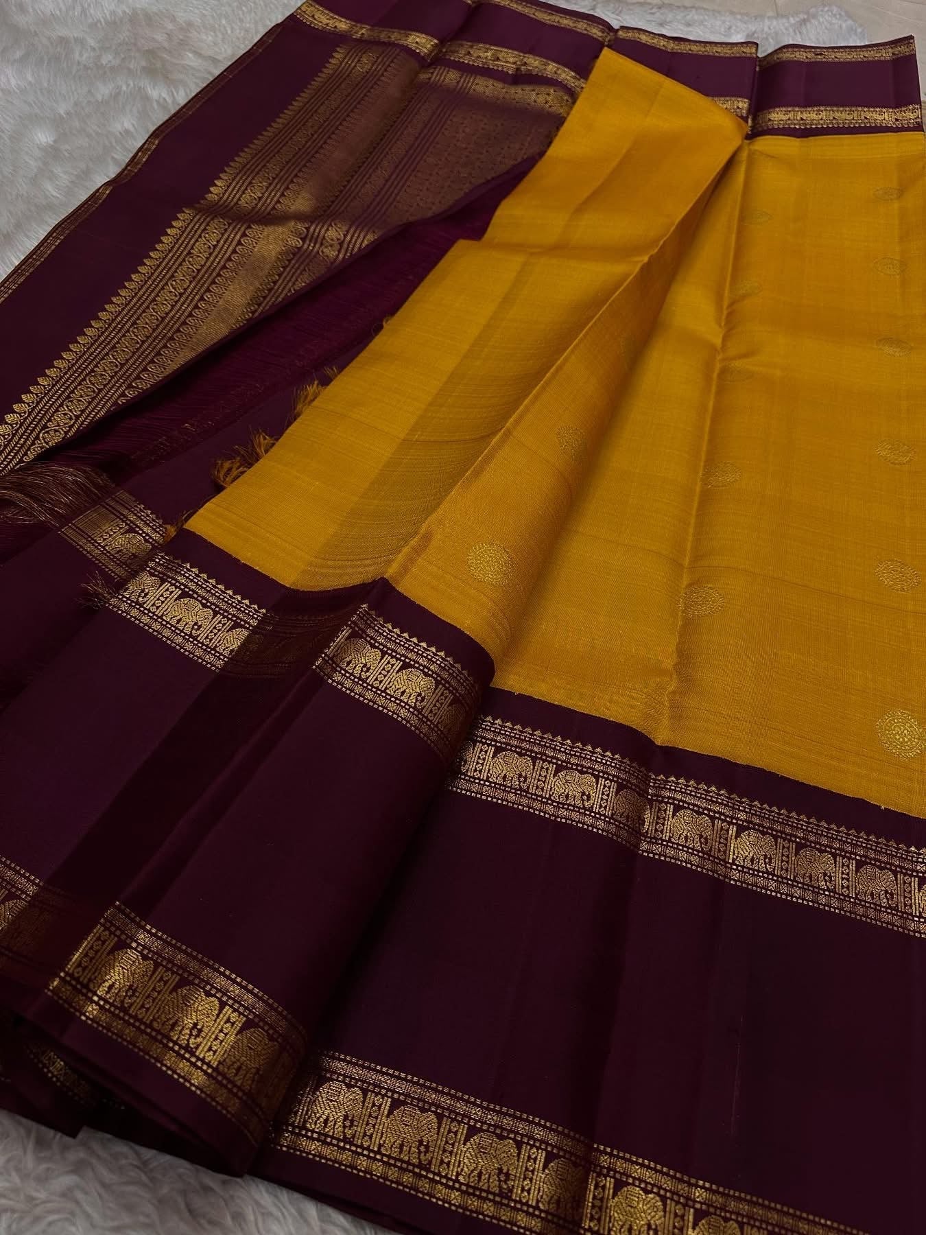 Bhanu – Mustard Gold Handwoven Kanchipuram Silk Saree with Deep Coffee Brown Borders, Intricate Elephant Motif Zari, and a Grand Temple-Inspired Pallu