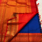 Kanchipuram silk saree pallu view with red-gold zari woven jaal and contrast blue section