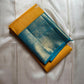 This radiant yellow pure silk drape is elevated by an exquisite and unexpected pairing — a serene sky blue border, making it both eye-catching and rare. Fine zari checks shimmer gently across the body, timeless bavaanji border