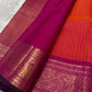 Sharvani – Orange & Magenta Pure Silk Kanchipuram Saree
Featuring zari-woven stripes across the body for subtle structure.
Bold magenta border with rice reed and peacock motifs, finished with a green selvedge.