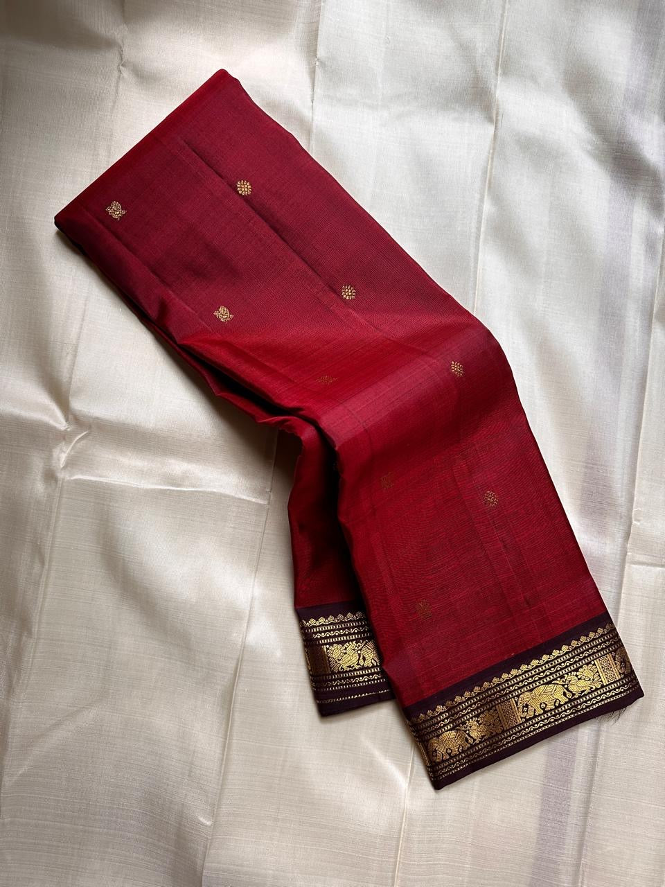 Ember ✨
Pure Kanchipuram Silk Saree in Ember Red & Coffee Brown
Ember-red body with delicate gold zari buttas
Rich coffee-brown elephant border with zari vines

Silk Mark Certified, delivery in 2 weeks